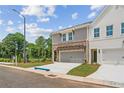 Beautiful townhouse with brick and gray siding, pergola over garage, and sidewalk at 4523 Moray Dr, Mableton, GA 30126