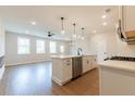 Bright kitchen with an island, stainless steel dishwasher, hardwood floors and open layout to living area at 4523 Moray Dr, Mableton, GA 30126