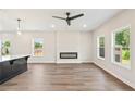 Spacious living room features modern fireplace, large windows, and recessed lighting with dark ceiling fan at 4523 Moray Dr, Mableton, GA 30126