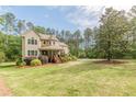 Charming two-story home featuring a stone turret and inviting front porch at 830 Hightower Trl, Oxford, GA 30054