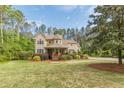 Charming two-story home featuring a stone turret and inviting front porch at 830 Hightower Trl, Oxford, GA 30054