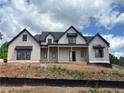 Beautiful new home with board and batten siding, dark trim, and a covered porch, set on a landscaped lot at 1089 Mount Carmel Church Ln, Canton, GA 30114