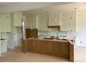 Unfinished kitchen with white cabinets and a center island awaits its final touches at 1089 Mount Carmel Church Ln, Canton, GA 30114