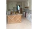 Bright kitchen displaying white cabinetry, custom vent hood and large unfinished island, awaiting countertops and appliances at 1089 Mount Carmel Church Ln, Canton, GA 30114