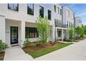 Modern townhome showcasing a black front door, black framed windows, and manicured landscaping at 2150 Tidwell Ln # 5, Atlanta, GA 30318