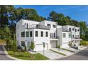 A striking townhome community showcasing modern design with white exteriors and black framed windows at 2150 Tidwell Ln # 5, Atlanta, GA 30318