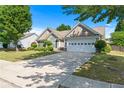 Inviting single-story home featuring a two-car garage, tidy landscaping, and a spacious driveway under a clear sky at 3134 Milloak Ct, Buford, GA 30519