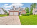 Beautiful brick front exterior featuring a well-manicured lawn, two-car garage, and classic design at 1016 E Bay Springs Dr, Villa Rica, GA 30180
