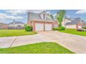 Lovely home with a two-car garage, green lawn, and traditional brick facade in a suburban setting at 1016 E Bay Springs Dr, Villa Rica, GA 30180