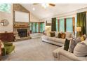 Cozy living room with a stone fireplace, large windows, plush seating, and ample natural light at 1359 Cedar Park Pl, Stone Mountain, GA 30083