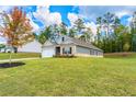 Well-maintained single-story home with green lawn, attractive landscaping, and an attached two-car garage at 426 Samara Ct, Fairburn, GA 30213