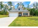 Charming single-story home with a brick and siding exterior, landscaped front yard, and attached garage at 426 Samara Ct, Fairburn, GA 30213