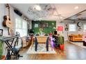 Eclectic dining room with unique ceiling and wall decor and hardwood floors at 569 Woods Nw Dr, Atlanta, GA 30318