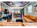 Stylish living room featuring hardwood floors and ceiling mural at 569 Woods Nw Dr, Atlanta, GA 30318