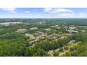 Aerial view of a neighborhood featuring mature trees and a variety of commercial and residential buildings at 615 Barrington Way, Roswell, GA 30076