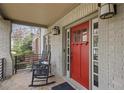 Inviting front porch with brickwork, rocking chairs, and a bright red front door at 101 Terrace Dr, Atlanta, GA 30305