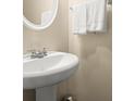 Close-up of a stylish pedestal sink with chrome fixtures and fresh white towels in a cozy bathroom at 2755 Greenbridge Dr, Norcross, GA 30071