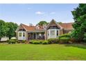 Charming brick home with manicured lawn and lush landscaping creating wonderful curb appeal at 5917 Southland Dr, Stone Mountain, GA 30087