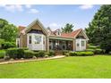 Charming brick home with manicured lawn and lush landscaping creating wonderful curb appeal at 5917 Southland Dr, Stone Mountain, GA 30087
