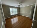 The bedroom has warm paint and wood floors at 1167 Drewsbury Ct, Smyrna, GA 30080
