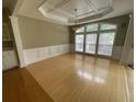 Spacious living room with hardwood floors, large windows, tray ceiling, and elegant trim at 1167 Drewsbury Ct, Smyrna, GA 30080