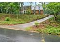 Classic two-story brick home featuring a long driveway and well-maintained front yard at 1825 Crescent Rdg, Cumming, GA 30041