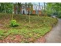 Charming two-story brick home with a well-manicured lawn and mature trees at 1825 Crescent Rdg, Cumming, GA 30041