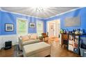 Bright blue living room with white trim and a view of the front door at 1825 Crescent Rdg, Cumming, GA 30041