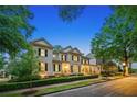 Charming two-story traditional home with black shutters, manicured landscaping and a sidewalk at 8109 Lawnview, Alpharetta, GA 30022