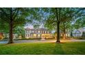 Lush trees surround this elegant two-story home with a large front yard and manicured landscaping at 8109 Lawnview, Alpharetta, GA 30022