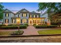 Elegant two-story home with black shutters, covered porch, brick walkway, and manicured landscaping at 8109 Lawnview, Alpharetta, GA 30022