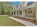 Inviting front porch with white columns, offering ample space for relaxing and enjoying the outdoors at 12 Cedar Gate Ln, Kingston, GA 30145