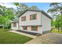 Charming two-story home featuring a freshly painted exterior and colorful shutters for added curb appeal at 1355 Tucker Woods Dr, Norcross, GA 30093