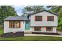 Charming two-story home featuring a freshly painted exterior and colorful shutters for added curb appeal at 1355 Tucker Woods Dr, Norcross, GA 30093