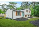 Charming two-story home featuring a freshly painted exterior and colorful shutters for added curb appeal at 1355 Tucker Woods Dr, Norcross, GA 30093