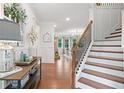 Bright foyer with wood floors, staircase, and decorative accents, creating an inviting entrance at 4120 Winterberry Rd, Cumming, GA 30040