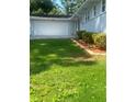 Two car garage with a well-maintained lawn and landscaped garden at 2251 S Hairston Rd, Decatur, GA 30035