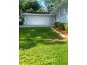 Exterior view of a two-car garage with manicured lawn and garden at 2251 S Hairston Rd, Decatur, GA 30035