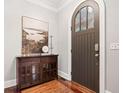 Inviting foyer features dark wood floors, arched door, and furniture at 3642 River Club Dr, Cumming, GA 30041