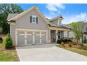 Lovely single-story home with attached two-car garage, landscaped yard, and inviting entryway at 207 Hickory Bluffs Pkwy, Canton, GA 30114