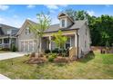 Attractive single-story home with a well-kept lawn, charming front porch, and attached garage at 207 Hickory Bluffs Pkwy, Canton, GA 30114
