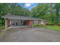 Quaint brick home with a convenient carport and lush green lawn at 1125 Lanier Sw Dr, Marietta, GA 30060