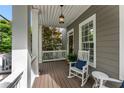 Inviting covered front porch with rocking chairs and stylish lighting at 1626 Gilstrap Nw Ln, Atlanta, GA 30318
