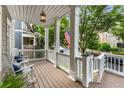 Inviting covered front porch with rocking chairs and stylish lighting at 1626 Gilstrap Nw Ln, Atlanta, GA 30318