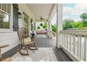 Relaxing front porch featuring comfortable seating, ceiling fan, and stylish decor, perfect for enjoying the outdoors at 172 Olympic Pl, Decatur, GA 30030