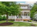 Charming front porch with a swing, rocking chairs, and manicured landscaping enhancing the curb appeal of this lovely home at 172 Olympic Pl, Decatur, GA 30030