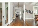 Elegant hallway with hardwood floors, decorative lighting, and neutral wall colors leading to various living spaces at 172 Olympic Pl, Decatur, GA 30030