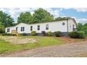 Charming single-story home with white siding and well-maintained landscaping at 1960 W Hightower Trl, Conyers, GA 30012