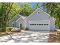 Lovely one-story home featuring a two-car garage, a mature tree, and a well-manicured lawn at 1965 Tiner Ct, Cumming, GA 30041