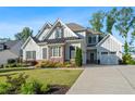 Beautiful two-story home with light-gray siding, brick accents, attached garage, and long driveway at 2208 Sage Mountain Sw Ct, Marietta, GA 30064
